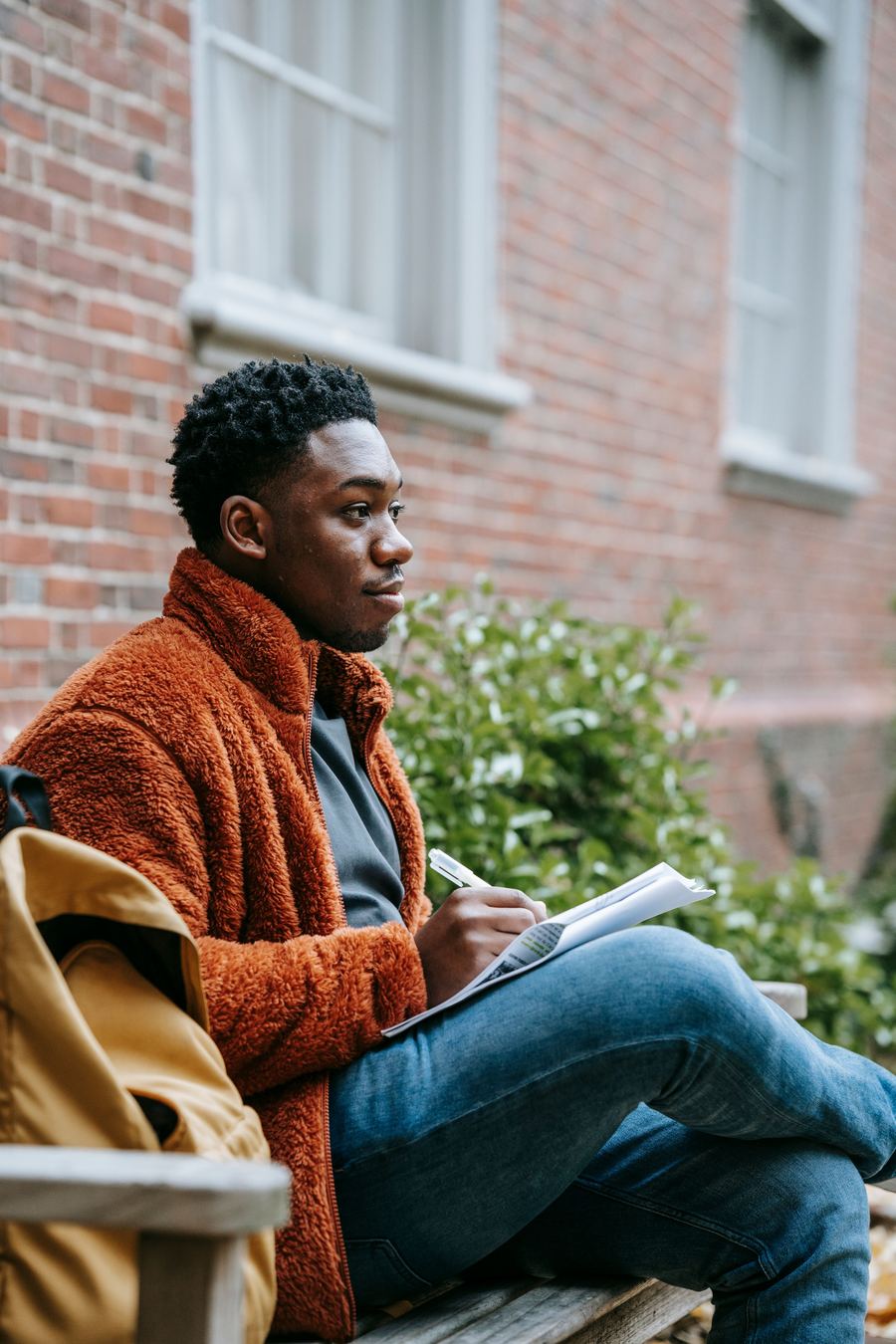 Student reviewing notes outside university building